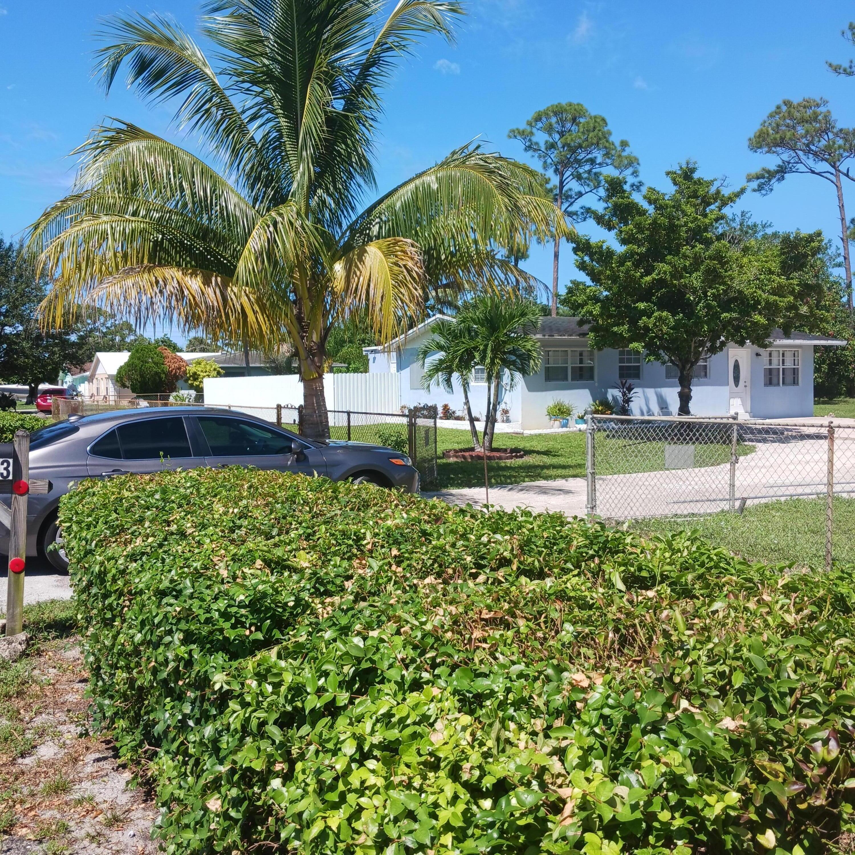 5783 Mango Road Royal Palm Estates, FL 33413 - Photo 5 of 47 a view of a yard with a palm tree