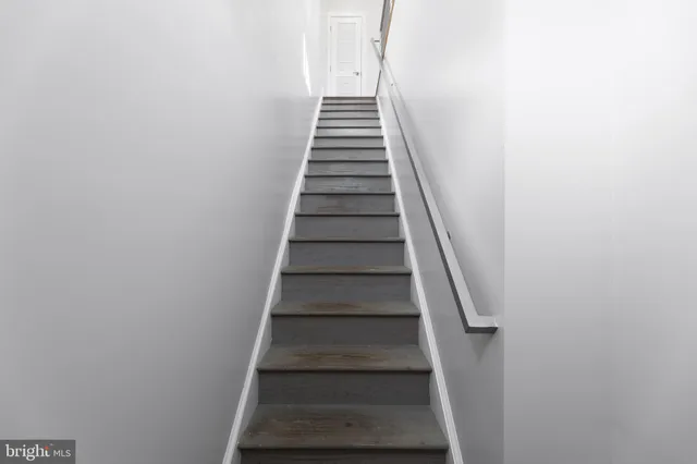 a front view of a house with a tree