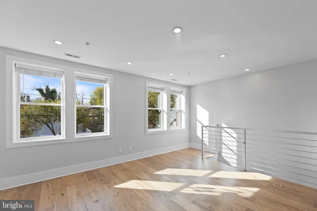 a view of a kitchen with refrigerator and chairs