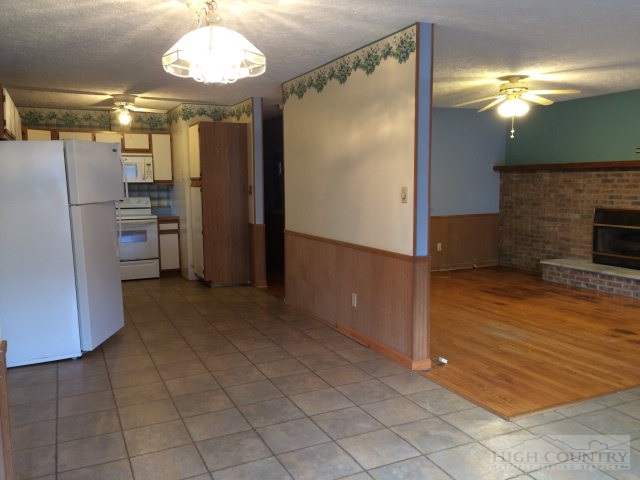 39 Painter Road Banner Elk, NC 28604 - Photo 15 of 17 a view of a refrigerator in kitchen and an empty room