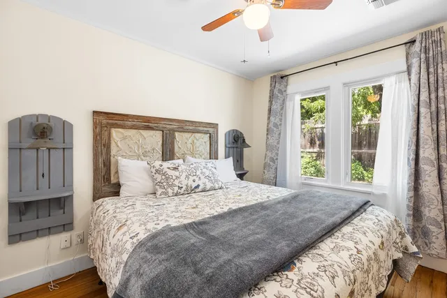 a bedroom with a large bed and a window