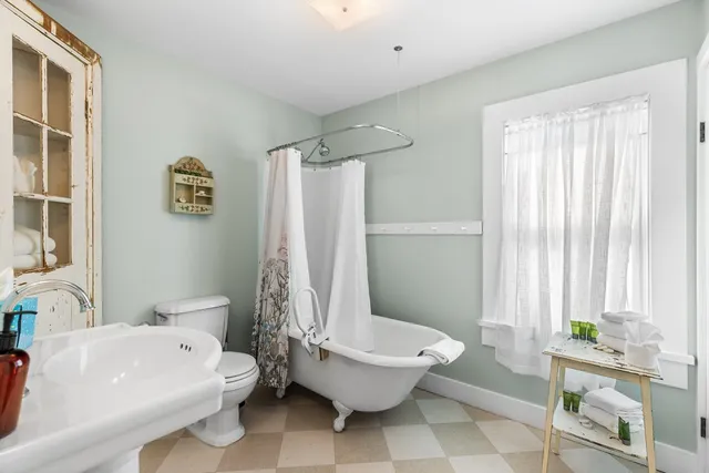 a white bath tub sitting next to a white toilet