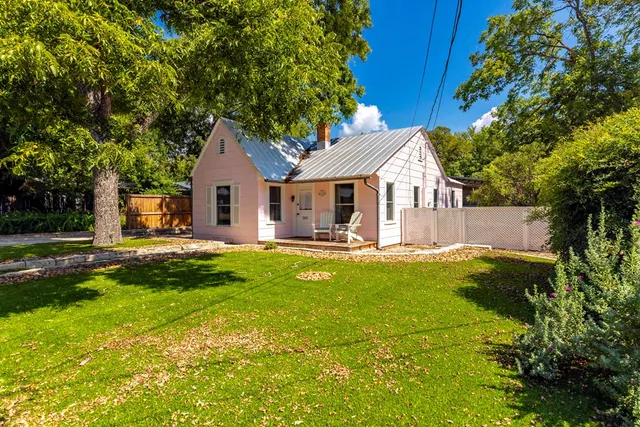 a front view of a house with yard and green space