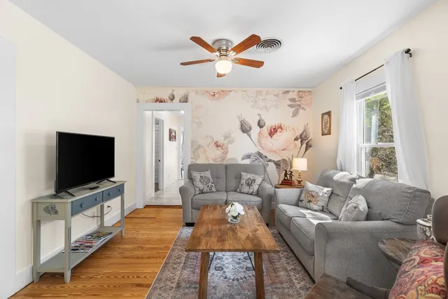a living room with furniture and a flat screen tv