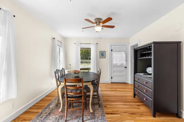 a view of a dining room with furniture and window