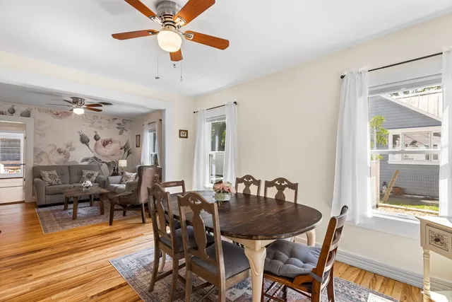 a view of a dining room with furniture and wooden floor