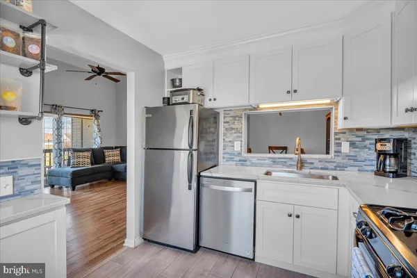 a kitchen with a sink stainless steel appliances and cabinets