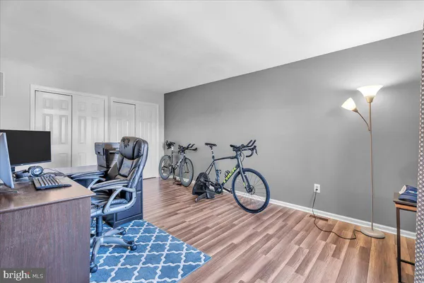 a view of a workspace with furniture and a bicycle