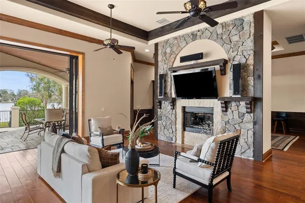 a living room with furniture a flat screen tv and a large window