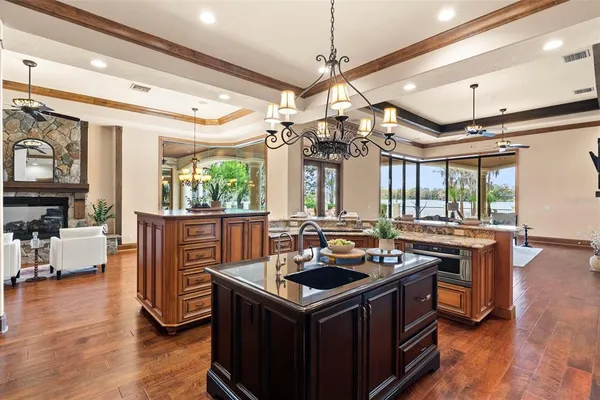 a bathroom with a granite countertop toilet a sink and a mirror