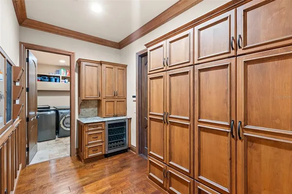 a view of balcony with two chairs and wooden fence