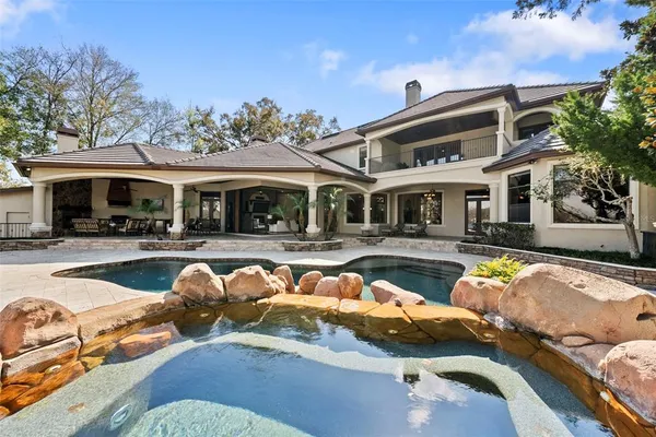 a dining room with furniture a chandelier and wooden floor