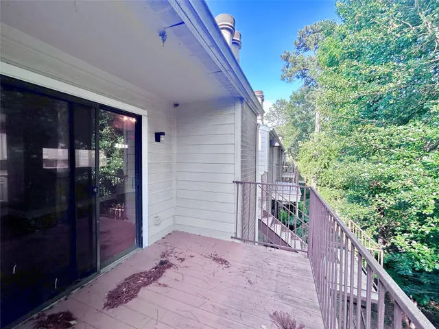 a balcony view with a backyard space