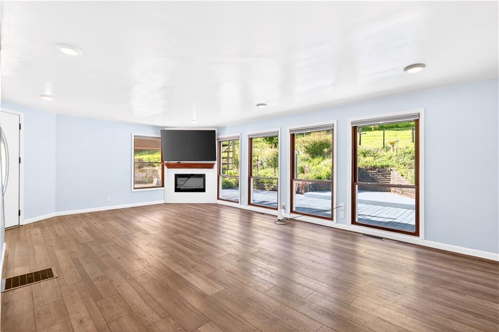 51 Kelley Road Canonsburg, PA 15317 - Photo 21 of 50 The huge living room with so much natural light, we loved the floor to ceiling windows, there is a lot of wildlife around this home, you will love It. You also have an electric fireplace to stay warm on those cool nights.