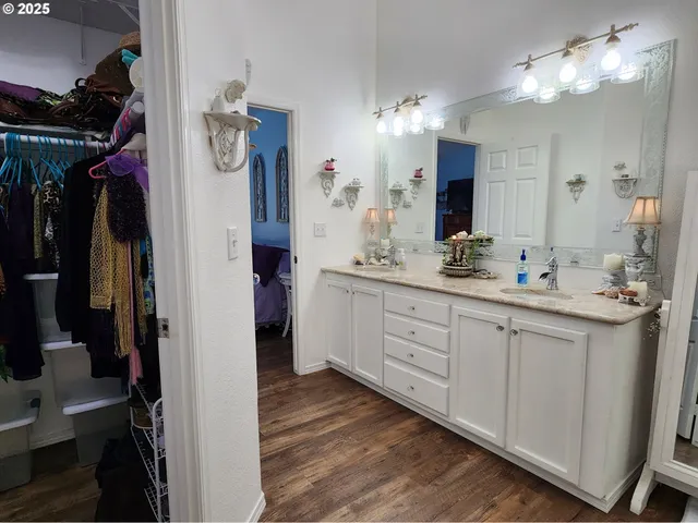 a spacious bathroom with a double vanity sink and a mirror