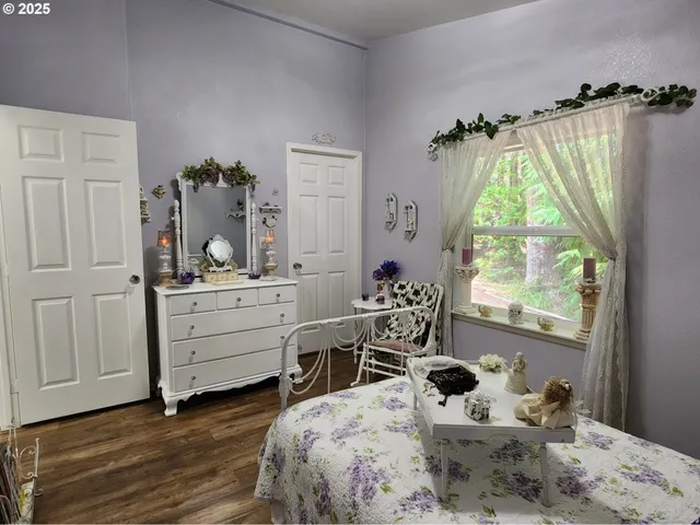 a bedroom with a bed and large windows