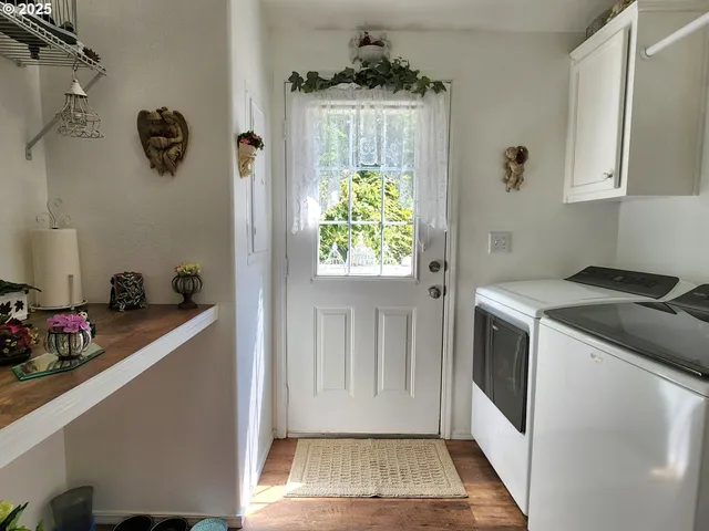 a utility room with cabinets washer and dryer
