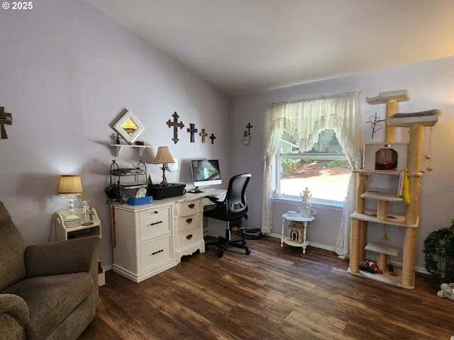 a view of a workspace with furniture and a window