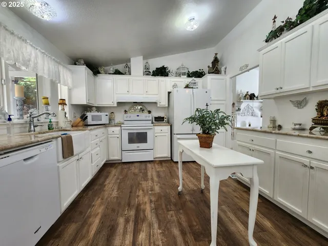 a kitchen with white cabinets stainless steel appliances and sink