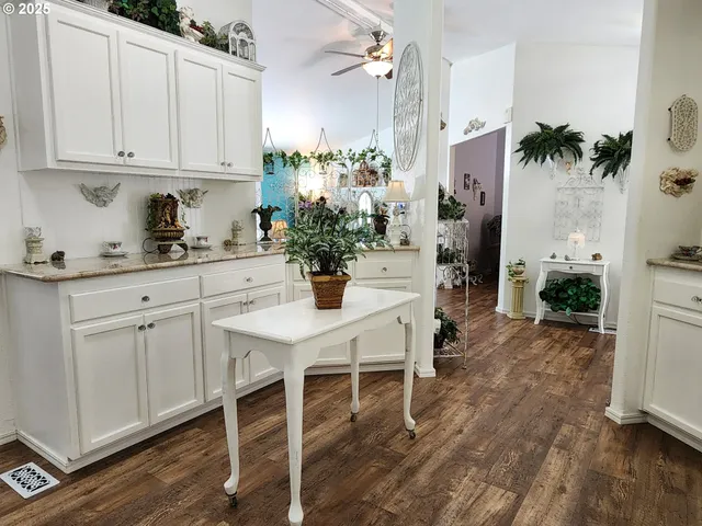 a kitchen with a white table and chairs in it