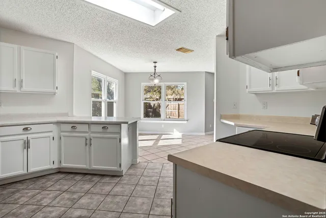a kitchen with a stove a sink and a refrigerator
