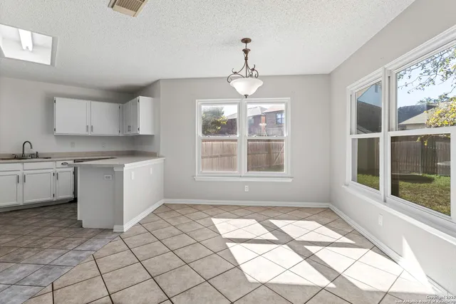a kitchen with stainless steel appliances granite countertop a stove a sink and a window