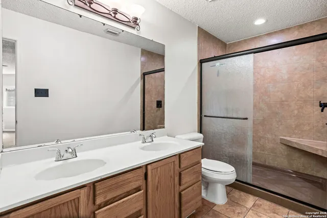 a bathroom with a sink toilet and shower