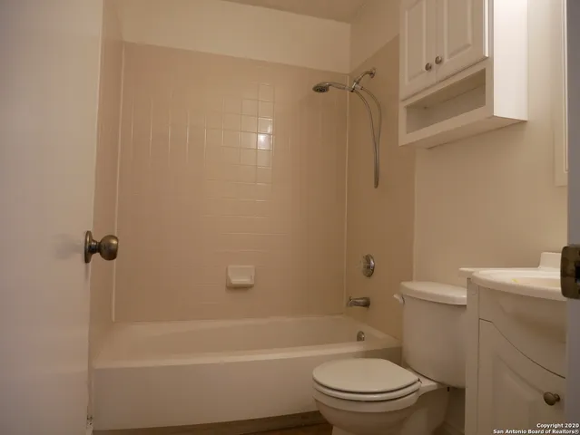 a view of a backyard with table and chairs and wooden fence