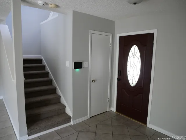a view of a entryway door with wooden floor