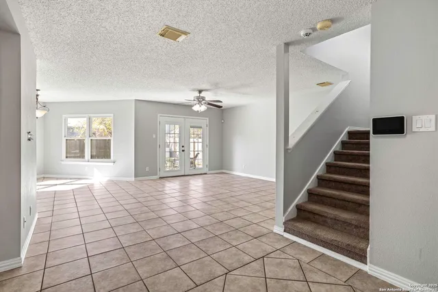 a view of an empty room with staircase