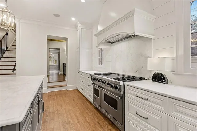 a kitchen with a stove and a wooden floor
