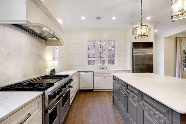 a kitchen with a stove and a refrigerator