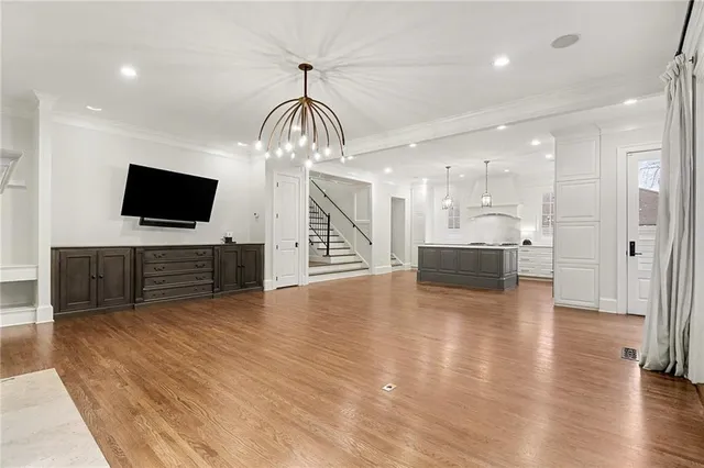 a view of a livingroom with furniture wooden floor and chandelier