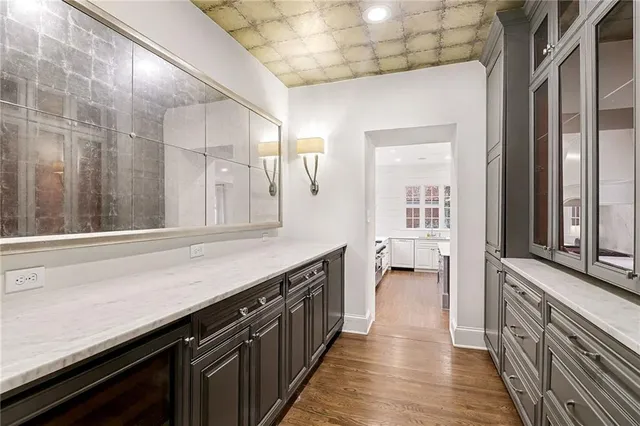 a kitchen with counter top space and wooden floor