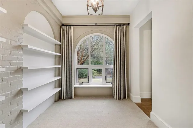 a view of a livingroom with furniture and staircase