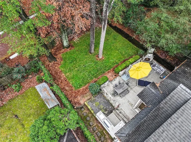 a view of a backyard with chairs and a table