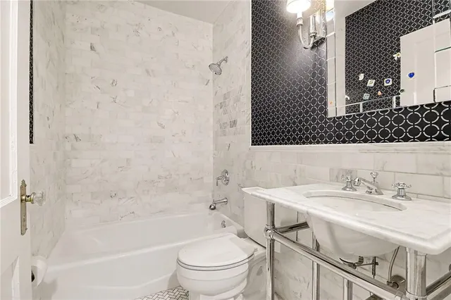 a bathroom with a sink toilet vanity and shower