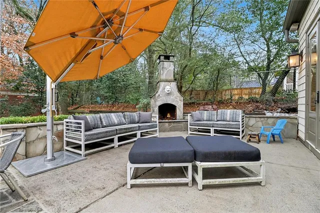 a view of a patio with a table and chairs under an umbrella