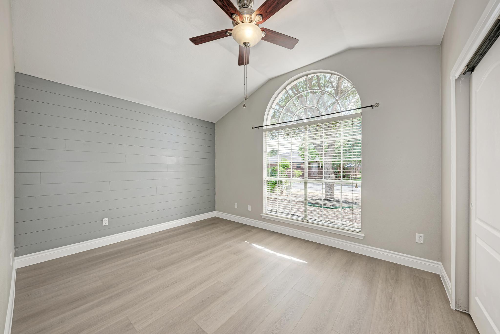 4408 Tello Path Austin, TX 78749 - Photo 25 of 38 Unfurnished room featuring light wood-style floors, lofted ceiling, and ceiling fan