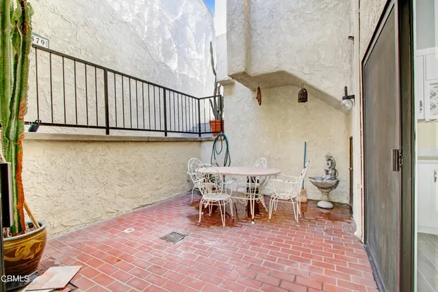 a view of a patio with table and chairs