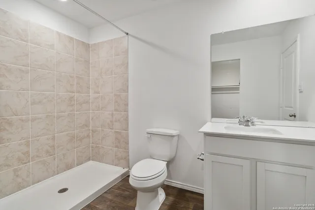 a bathroom with a sink toilet and shower
