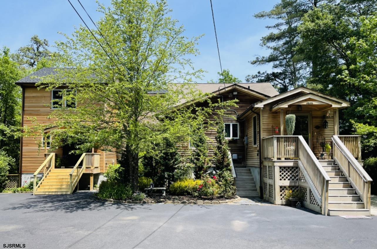 4646 Riverside Drive Sweetwater, NJ 08037 - Photo 2 of 55 a front view of a house with a garden