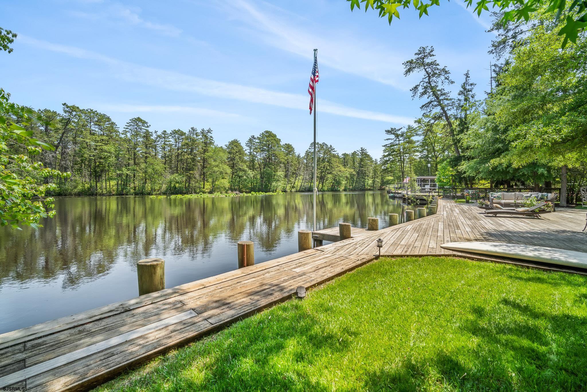 4646 Riverside Drive Sweetwater, NJ 08037 - Photo 25 of 55 a view of a lake with a yard and large trees