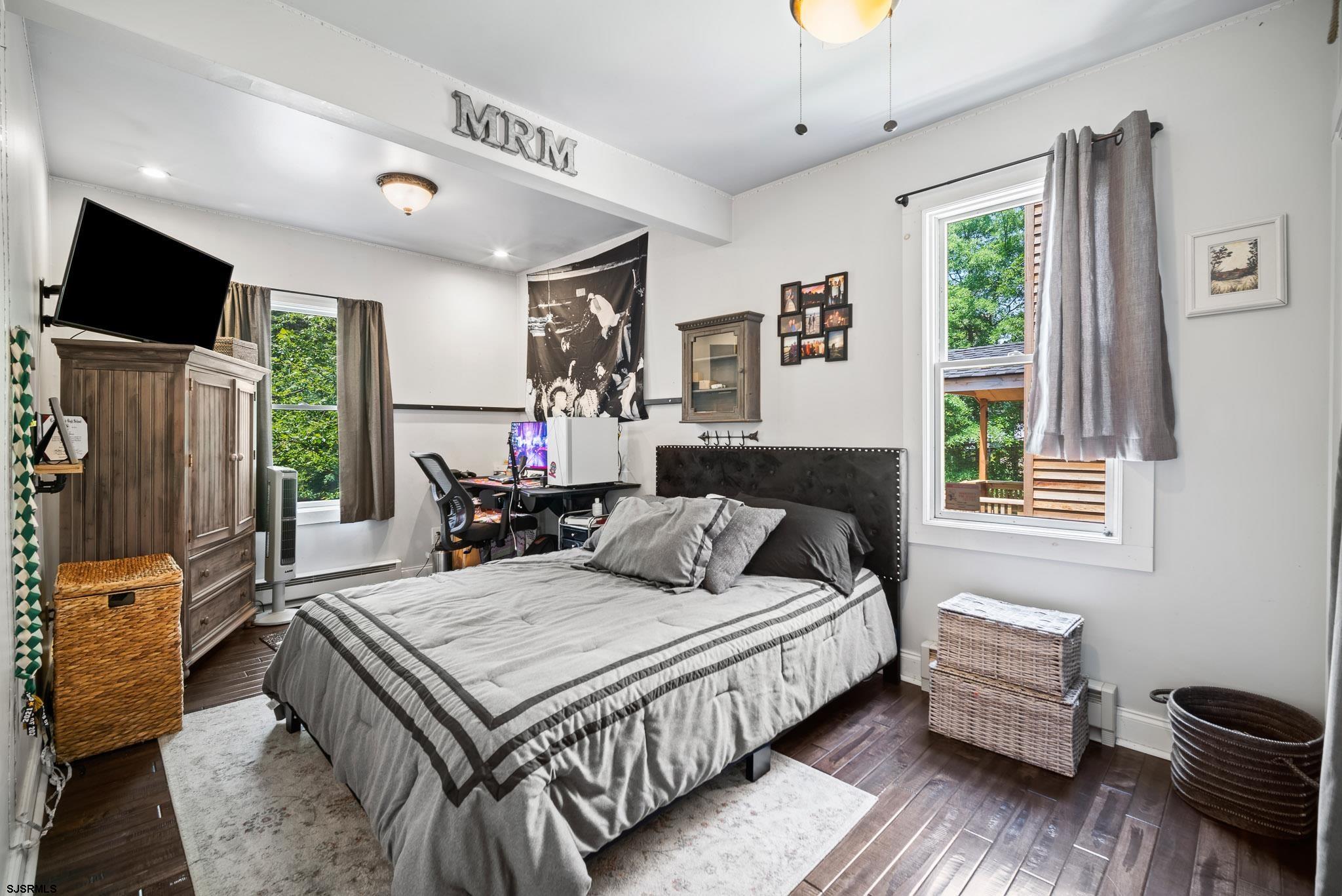 4646 Riverside Drive Sweetwater, NJ 08037 - Photo 33 of 55 a bedroom with a bed a flat screen tv and a couch