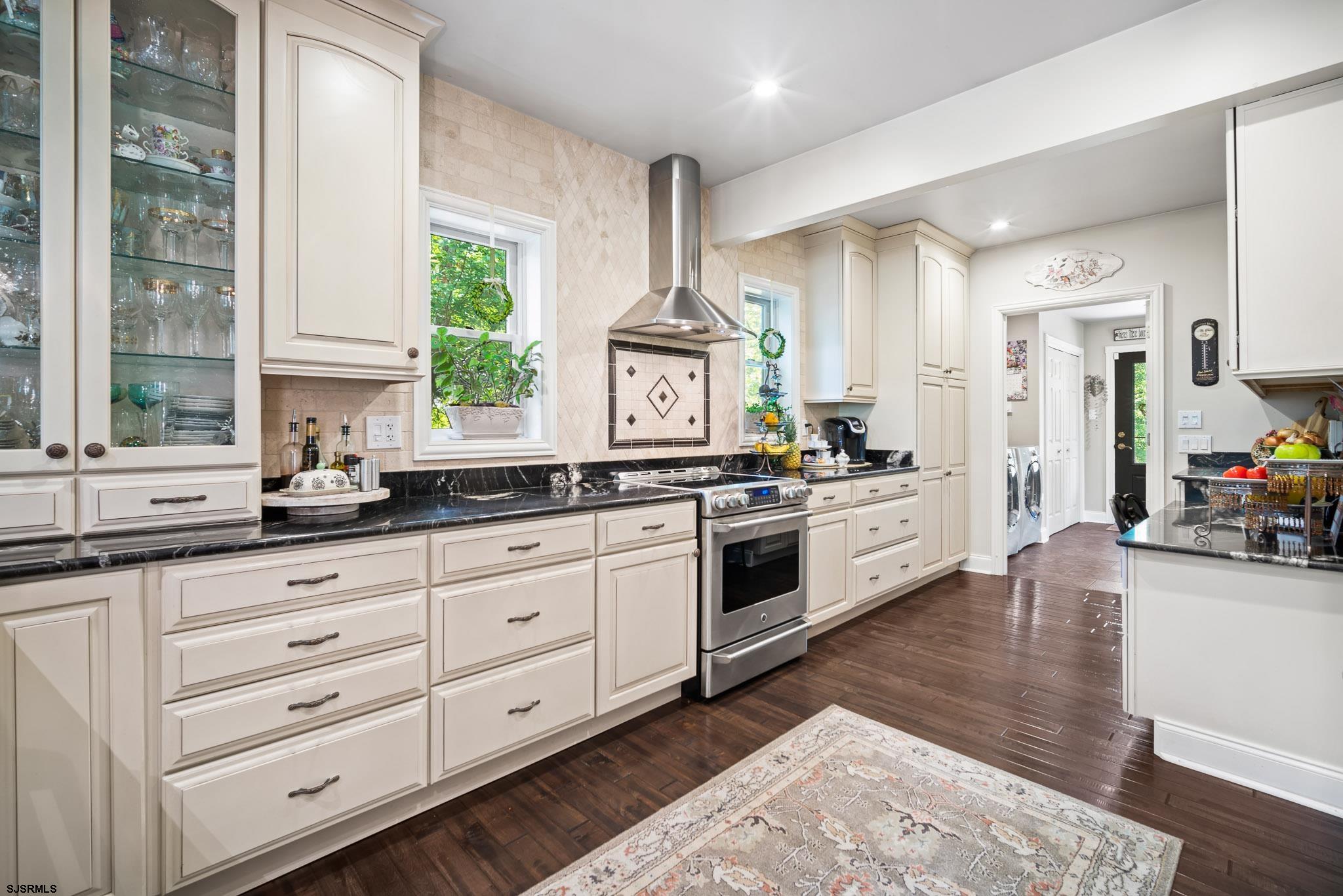 4646 Riverside Drive Sweetwater, NJ 08037 - Photo 39 of 55 a kitchen with granite countertop white cabinets and white appliances