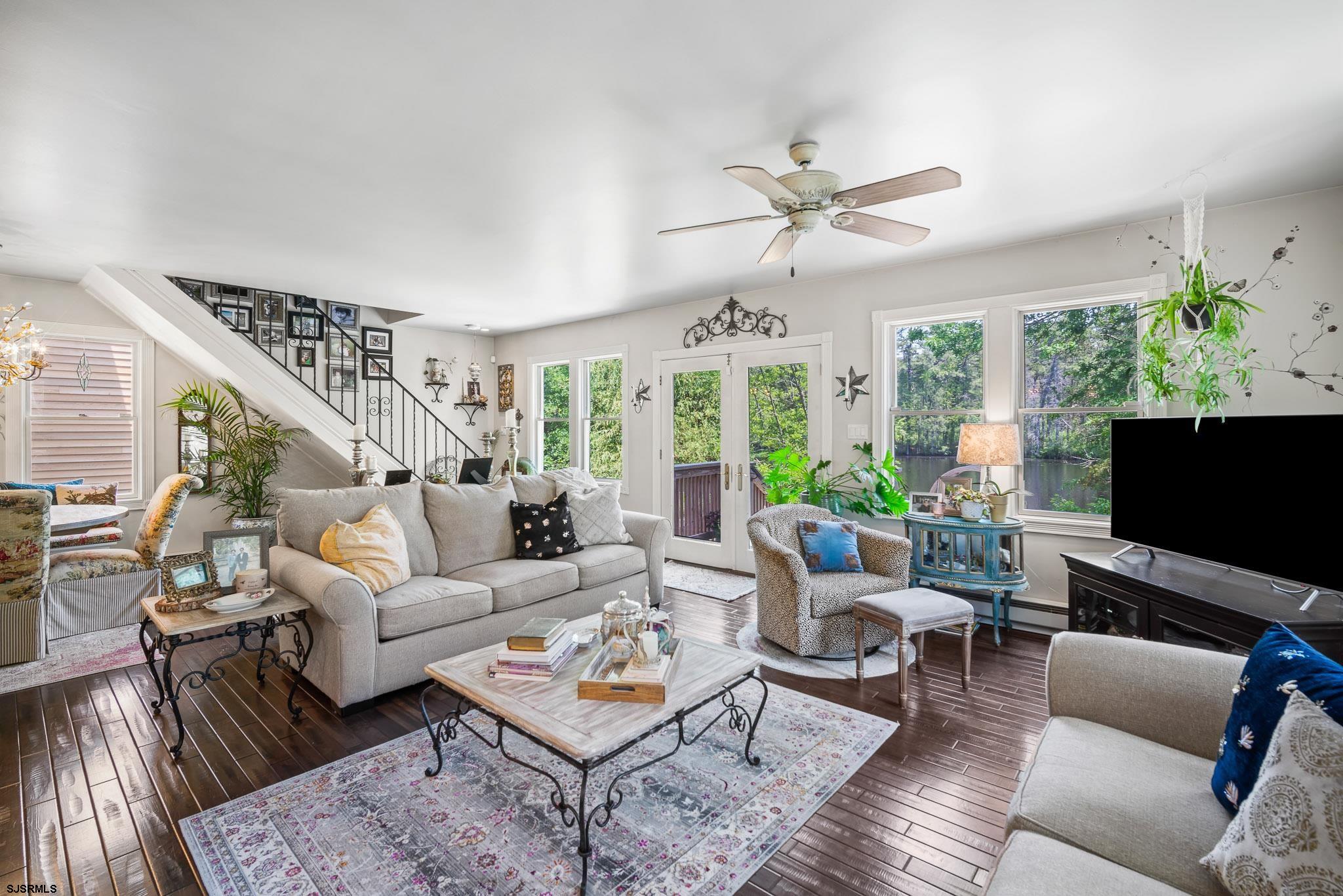 4646 Riverside Drive Sweetwater, NJ 08037 - Photo 41 of 55 a living room with furniture a flat screen tv and a large window