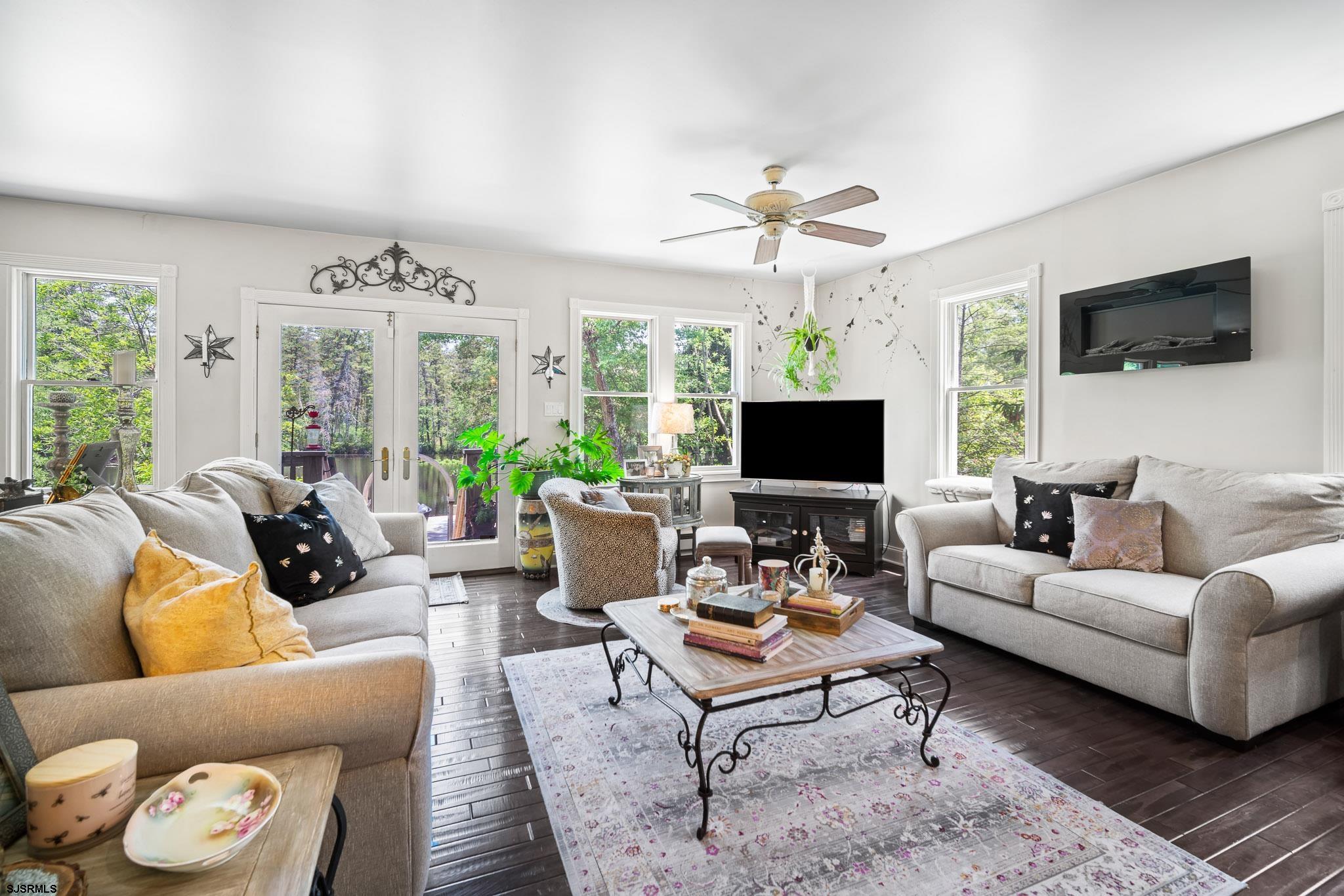 4646 Riverside Drive Sweetwater, NJ 08037 - Photo 55 of 55 a living room with furniture a flat screen tv and a large window