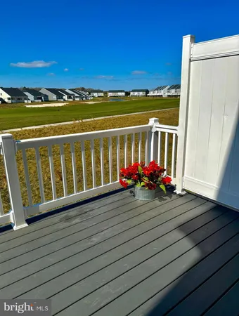 a view of a balcony with wooden floor and city view