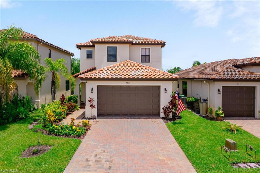 5519 Useppa Drive Ave Maria, FL 34142 - Photo 1 of 32 a front view of a house with a yard and garage