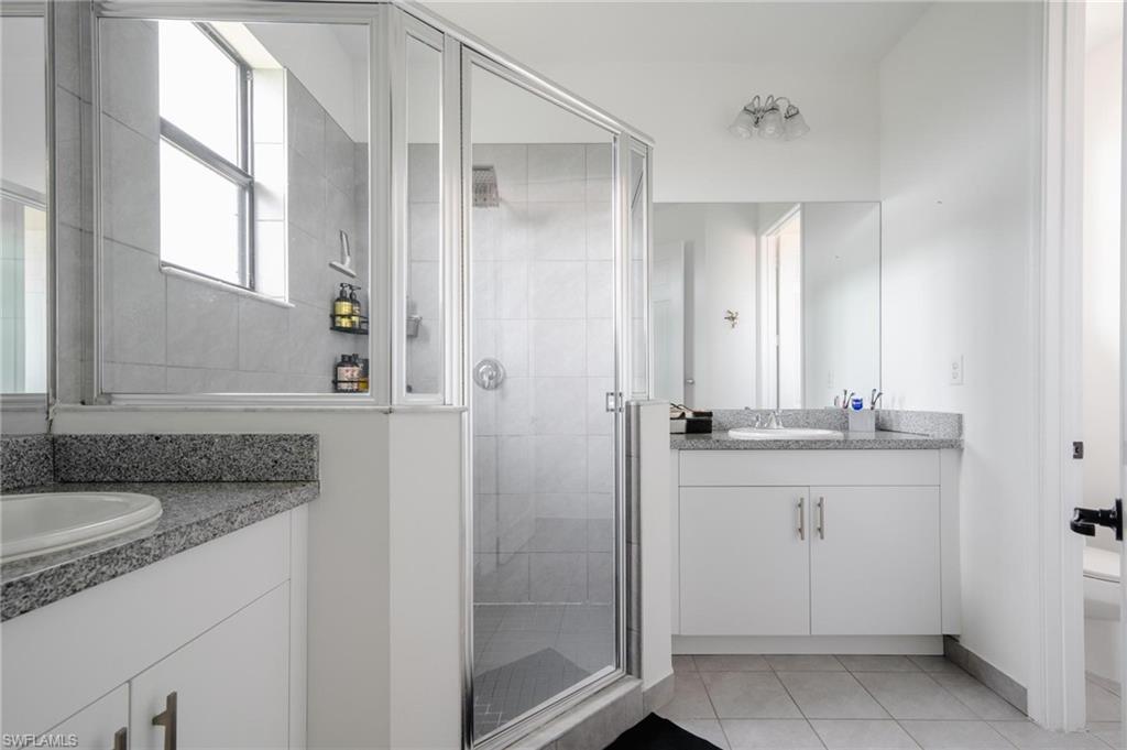 5519 Useppa Drive Ave Maria, FL 34142 - Photo 15 of 32 a bathroom with a granite countertop sink and a mirror